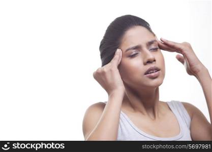 Close-up of young woman suffering from headache isolated over white background