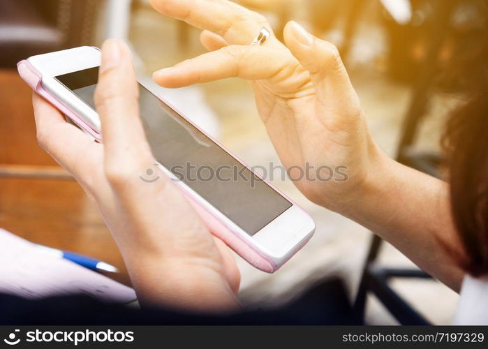 Close up of Young woman using smart phone in cafe