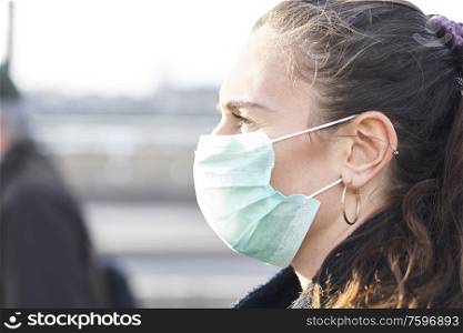 Close Up Of Young woman wearing face mask while walking in the streets of London