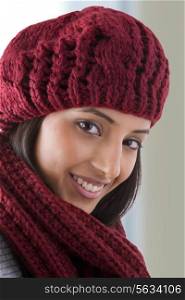 Close-up of young woman wearing woolen hat and smiling