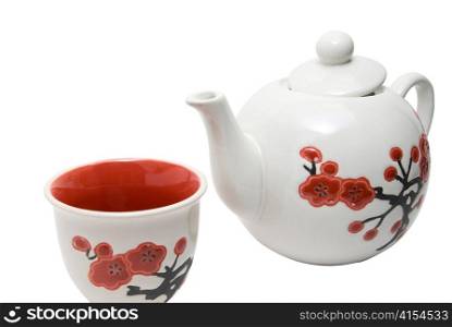 Close-up off tea-things in asian style with flowers. Isolated on white.
