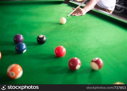 close up ofman playing a snooker or billiard in club.