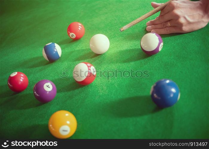 close up ofman playing a snooker or billiard in club.