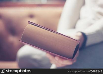 Close up on a big book in the hand of a man