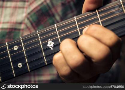 Close up on a hand playing guitar