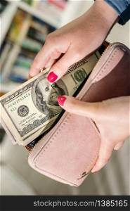 Close up on american USD dollars money banknotes in hand unknown caucasian woman holding putting wallet after receiving payment loan help financial aid support due economic recession crisis top view