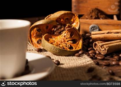 Close-up on dried orange fruit and cinnamon sticks with coffee beans. Close-up on dried orange fruit and cinnamon sticks