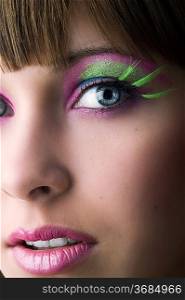 close up on face of beautiful girl with green long eyelashes
