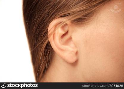 Close up on female ear. Detail of the head with female human ear and hair close up