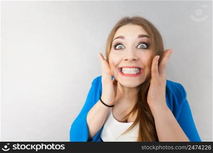 Close up on funny woman expression. Female lady being surprised shocked having wide opened eyes.. Funny woman being shocked