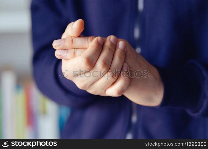 Close up on hand midsection of young caucasian man male hands holding together fingers in day