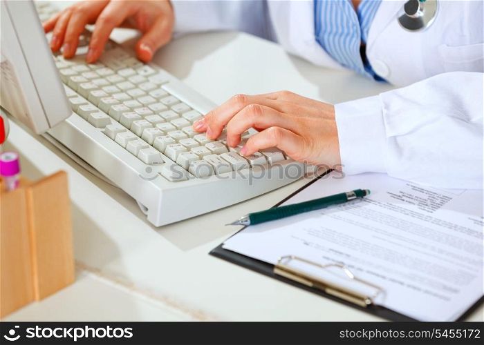Close-up on hands of female medical doctor woman working at table&#xA;