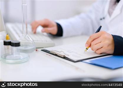 Close-up on hands of medical doctor working at office table&#xA;