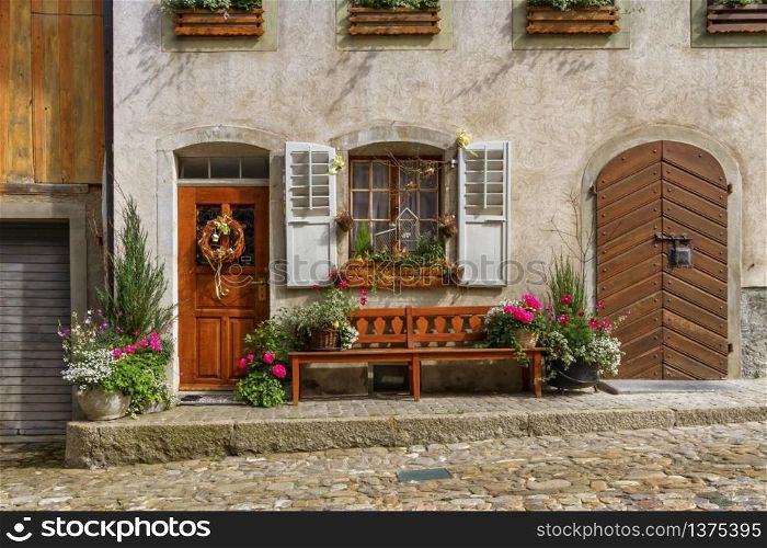 Close up on houses in Gruyere village in Fribourg canton by beautiful day, Switzerland. Gruyere village in Fribourg canton, Switzerland