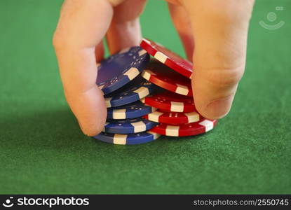 Close up on man&acute;s hand doing a pocker chip trick &acute;shuffle&acute;