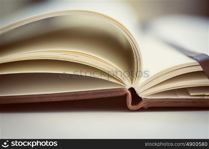Close up on open book pages.Toned.. Opened book on the table. Close up.