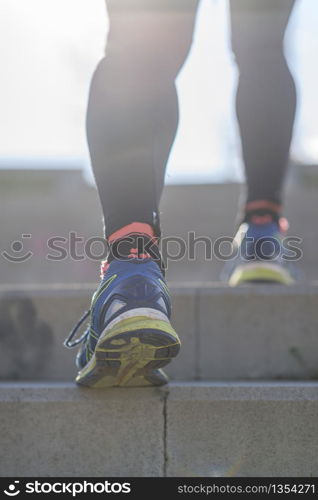 Close up on running shoe of a senior man having runner stretching before the run - Athlete preparing position to start a run