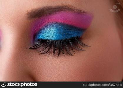 close up on the eye of a beauty model with colorful and creative make up