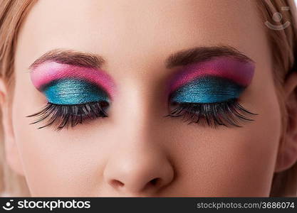 close up on the eyes of a beauty model with colorful and creative make up