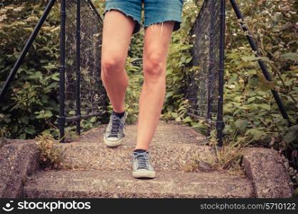 Close up on the legs of a young woman as she is standing outside in nature on a spring day