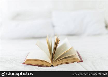 close up open book bed