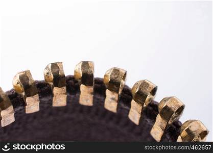 Close up or macro of a brown zipper on white background