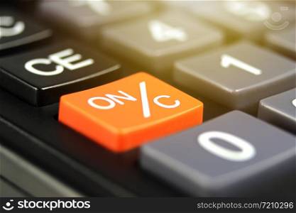 Close up orange power button (ON/C) in calculator.