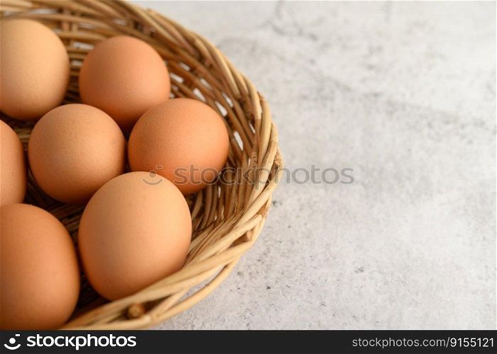 Close up organic brown eggs several in a wicker basket, preparing preparing for cooking food or dessert, copy space