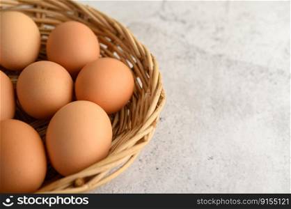 Close up organic brown eggs several in a wicker basket, preparing preparing for cooking food or dessert, copy space