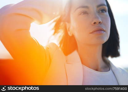 Close up outdoor lifestyle portrait of beautiful young woman. Freedom and independence. Soft colors.