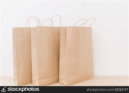 close up paper shopping bags wooden desk