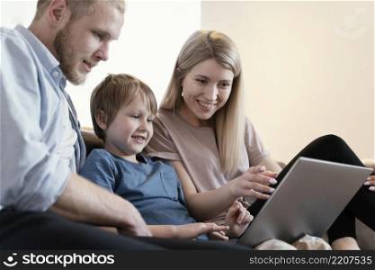 close up parents kid with laptop