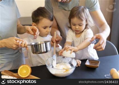 close up parents kids making dough