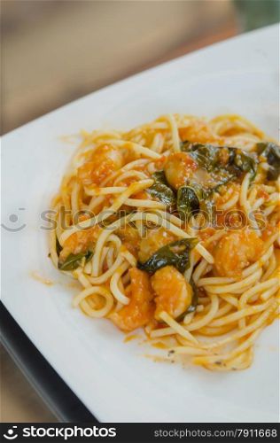 close up pasta with tomato sauce , shrimp and vegetable