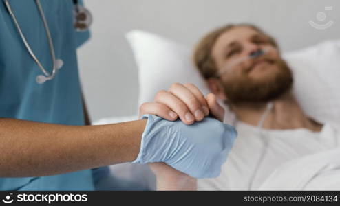 close up patient health worker holding hands