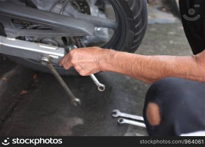 Close up,People are repairing a motorcycle .