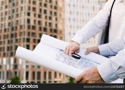 close up people holding building sketch