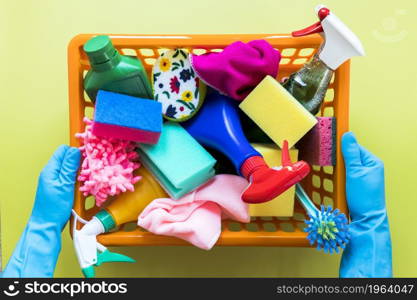 close up person holding basket with cleaning products. High resolution photo. close up person holding basket with cleaning products. High quality photo