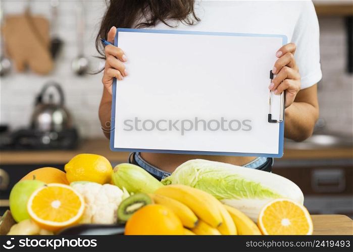 close up person holding up clipboard
