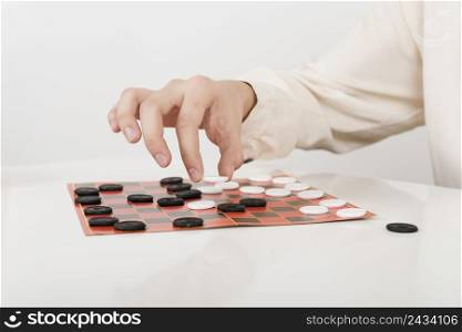 close up person playing checkers