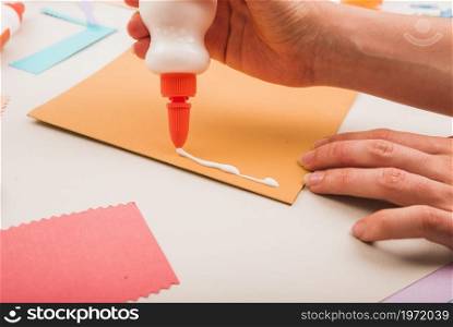 close up person s hand applying white glue paper. High resolution photo. close up person s hand applying white glue paper. High quality photo