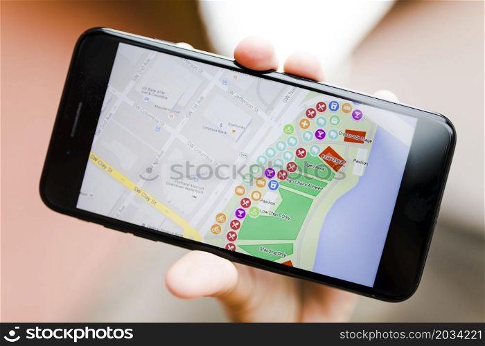 close up person s hand holding smartphone with map gps navigation