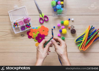 close up person s hand making handmade jewelry