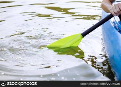 close up person s hand paddling kayak