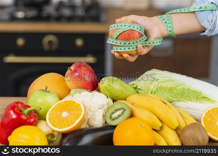 close up person with fruits arrangement
