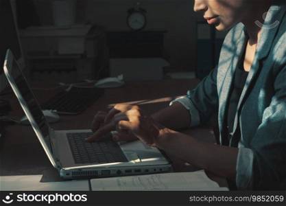 Close up photo of a beautiful serious woman working, doing homework or working online at home. Home office for freelancers.. Serious business woman working on laptop