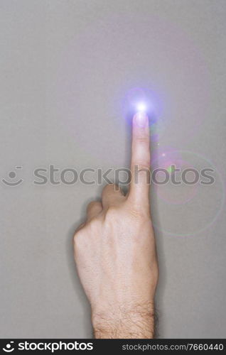 Close up photo of man finger with lens flare 