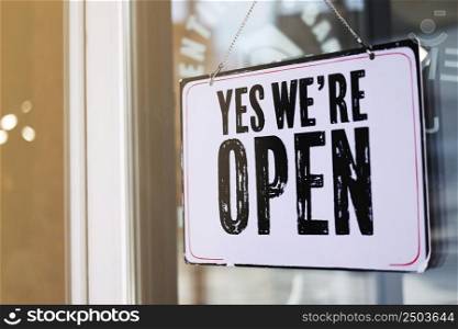 close up photo of signboard yeas we are open on door on blur background. cafe, salon, restaurant ready to work. promotion business concept. close up photo of signboard yeas we are open on door on blur background. cafe, salon, restaurant ready to work. promotion business concept.