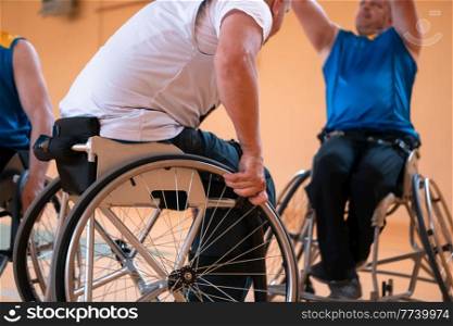 Close up photo of wheelchairs and handicapped war veterans playing basketball on the court. Selective focus. . Close up photo of wheelchairs and handicapped war veterans playing basketball on the court