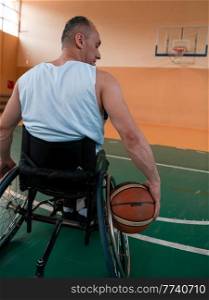 Close up photo of wheelchairs and handicapped war veterans playing basketball on the court. Selective focus . Close up photo of wheelchairs and handicapped war veterans playing basketball on the court